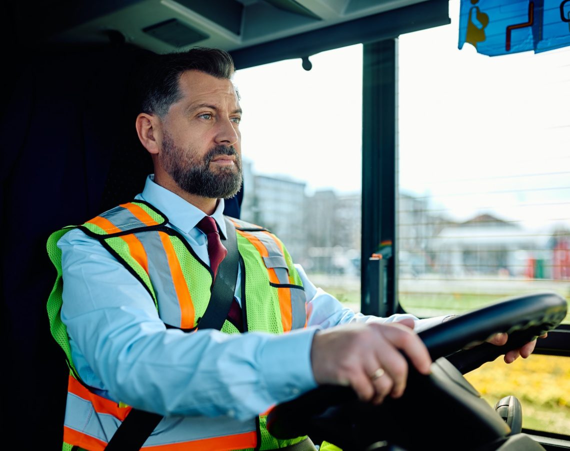 Bus driver driving a bus in the city. Bus driver driving a bus in the city.